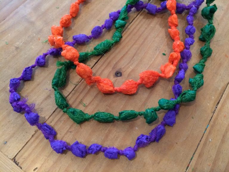 DIY Mardi Gras beads from plastic produce bags and table cloths - designed by Trashmagination