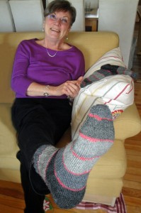 Mom showing off her socks with yarn leftovers